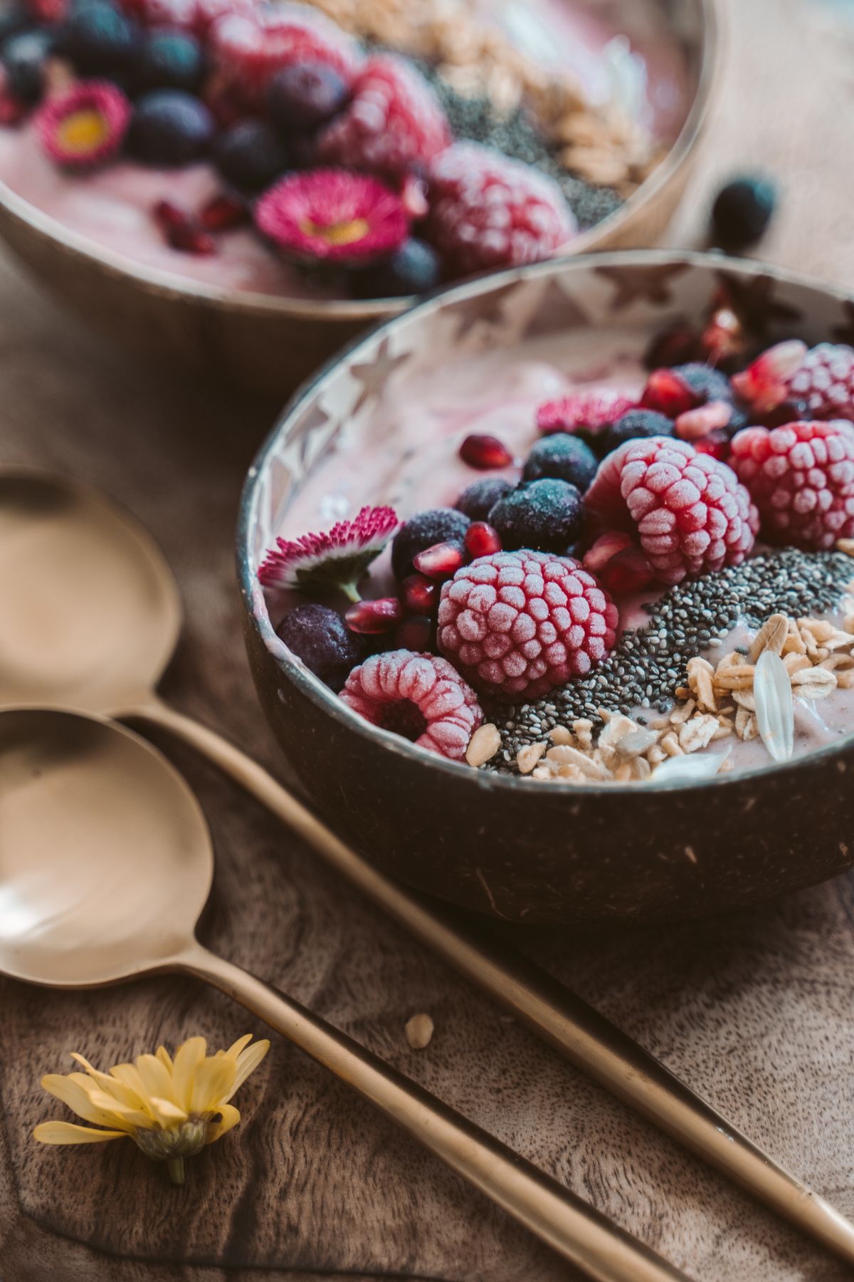 Smoothie bowl topped with fresh berries, granola, and chia seeds